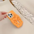 Close-up of orange silicone phone case with unique hollow foam runner design for iPhone. - Yellow / iPhone 14 Pro Max