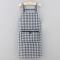 Classic black and white plaid kitchen apron with cross-back straps and front zipper pocket. - Gray