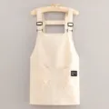 Beige short canvas work apron with double pockets and adjustable straps for kitchen use. - Beige
