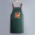 Waterproof kitchen apron with back straps, solid green cooking workwear, practical pocket design. - Regular Fit / Dark Green