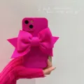 Close-up detail of hot pink phone case featuring a large oversized fabric bow decoration. - Rose Red 3D Bowknot / 7/8/se2
