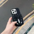 Detail view of black silicone phone case with trendy hollow clog shoe design for iPhone. - Black / iPhone 14 Pro Max