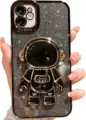 Close-up detail of luxury glitter black phone case featuring a 3D gold plated astronaut stand. - Black