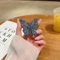 Blauer metallischer Schmetterling Handyhalter, kreativer klappbarer Klebehalter für Smartphone. - Blau