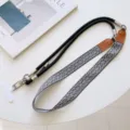 Black white geometric pattern phone lanyard with crossbody strap and metal hardware details. - Style #11