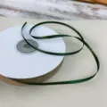 Green Christmas ribbon with double-sided gold edge, perfect for gift boxes and holiday decor. - 3mm / 40 Yards / Christmas Green