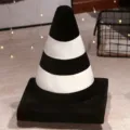 Black and white striped plush traffic cone shaped throw pillow for home decoration. - Black