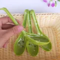 Green melamine soup spoon detail showing the cute white floral pattern inside the bowl for dining. - Soup Spoon / Green