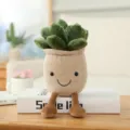Cute plush succulent potted toy with smiley face and dangling legs for home living room decor. - Succulent Ornament (25cm) / Beige