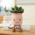 Cute succulent plush toy potted plant with dangling legs and smiling face for home decor. - Succulent Ornament (25cm) / Pink