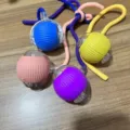 Colorful electric pet toy rolling ball with hanging rope for cats and dogs entertaining. - Cat Ball with Rope Blue