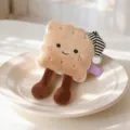 Cute biscuit plush toy with striped sleeping cap and dangling legs, soft stuffed doll decoration. - Cookie