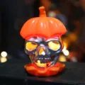 Atmospheric Halloween silver skull LED candle light with glowing orange pumpkin cap - Orange Skeleton