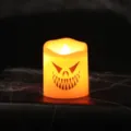 Halloween LED electronic candle with scary monster face and warm orange glow for party decor - Triangle Mouth Ghost Face