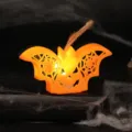 Orange bat-shaped LED Halloween lamp with spider web cutouts and warm glowing effect - Two-color Bat Lamp