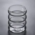 Detailed view of the grey ribbed glass cup, showcasing unique wave texture and quality. - 301-400ml / Clear