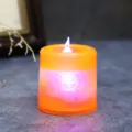 Halloween LED candle with bat design glowing in orange and purple tones - Small orange bat