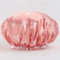 Pink satin shower cap with cute white bows, waterproof double layer hair bonnet for bathing. - Double-Layer Shower Cap Pink