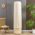 Detail view of a white lace dust cover for standing air conditioner with elegant tassel hem. - Universal Fit for All Brands (Height 175 cm) / Wheat Ear Coffee Stay-on Cover