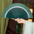 Chinese vintage folding fan with green silk, lace trim, and bamboo ribs for Hanfu style summer. - Green Crown Style with Pendant / Green