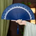 Traditional Chinese style folding fan with silk surface and bamboo ribs, portable for summer Hanfu. - Blue