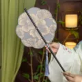 Traditional Chinese Hanfu round fan with exquisite floral embroidery and elegant tassel pendant. - 8-Petal Qin Zhi Waist Fan (Bamboo Edge)