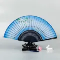 Traditional Chinese folding silk fan with elegant floral design, wooden ribs and display stand. - Floral Leaves / Blue