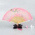 Traditional Chinese style silk folding fan with elegant floral design and wooden frame display. - Floral Leaves / Pink