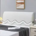 Detail view of white textured headboard cover with wavy ruffled edge and side pocket. - Dreamy Beige