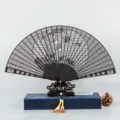 Traditional Chinese folding fan with exquisite hollow carved wooden design, elegant gift style. - Ebony Bamboo and Crane