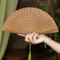 Natural sandalwood folding fan with green tassel, ancient Chinese Hanfu accessory. - Ningrui Green Sandalwood