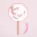 Traditional Chinese palace fan with wooden handle and pink tassel, perfect for Hanfu dance. - Eight-Petal Plum and Swallow Fragrance Fans