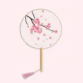 Traditional Chinese round fan with cherry blossom pattern, wooden handle, and pink tassel. - Dancing Cherry Blossoms - Raw Wood Handle