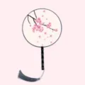 Traditional Chinese round fan with cherry blossom pattern, black handle, grey tassel. - Falling Sakura Dance - Black Handle
