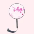 Traditional Chinese round fan with pink floral pattern, black handle and grey tassel. - Peach Blossom Face Black Handle
