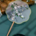 Traditional Chinese vintage embroidered round palace fan with wooden handle and green tassel. - Double-Sided Embroidered 8-Petal Fan - Vibrant Green (Beechwood Handle)