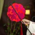 Traditional Chinese style red embroidered fan with bamboo handle and tassel, Hanfu accessory. - 8-Petal Red Rose Waist Fan (Bamboo Edge)