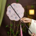 Traditional Chinese style folding round fan with butterfly embroidery and pink tassel handle. - 8-Petal Fluttering Butterflies Waist Fan (Bamboo Edge)