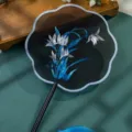 Traditional Chinese style embroidered round fan with delicate floral pattern and elegant tassel. - Double-Sided Embroidered 8-Petal Fan - Orchid on Black Background (Beechwood Handle)