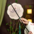 Traditional Chinese embroidered round fan with bamboo handle and elegant green tassel for Hanfu. - 8-Petal Peony Flower Waist Fan (Bamboo Edge)
