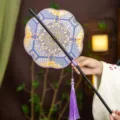 Traditional Chinese round fan with purple tassel, blue gold silk fabric, elegant Hanfu prop. - 8-Petal Gentle Waist Fan (Bamboo Edge)
