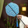 Chinese traditional blue floral round fan with black bamboo handle and elegant tassel for Hanfu. - Lily Qimo Waist Fan (Bamboo Edge)