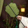 Traditional Chinese Hanfu waist fan, vintage green bamboo folding fan with elegant tassel decor. - Flying Thread Green Mountains Waist Fan (Bamboo Edge)