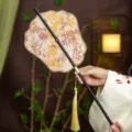 Traditional Chinese style hand fan with bamboo handle, floral fabric and elegant tassel for Hanfu. - Phoenix Crown Brocade Jade Waist Fan (Bamboo Edge)