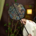 Chinese vintage Hanfu waist fan with bamboo handle, brocade pattern and black tassel. - 8-Petal Colorful Quest Waist Fan (Bamboo Edge)