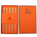 Wooden chopsticks gift set with 5 pairs in an elegant orange box, premium design for home use. - 5 Pairs of Yellow Sandalwood Gift Chopsticks