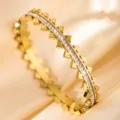 Gold titanium steel bangle featuring sparkling cubic zirconia and chic pyramid studs. - DQ-2446-3
