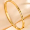 Gold titanium steel bangle detail featuring a delicate sparkling crystal and elegant slot design. - DQ-2443-1
