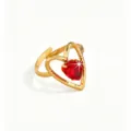 Close-up detail of the gold heart-shaped ring with brilliant red cubic zirconia stone. - Red Heart