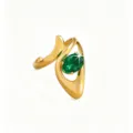 Close-up detail of the elegant gold asymmetrical ring with sparkling green stone embellishment. - Green Oval